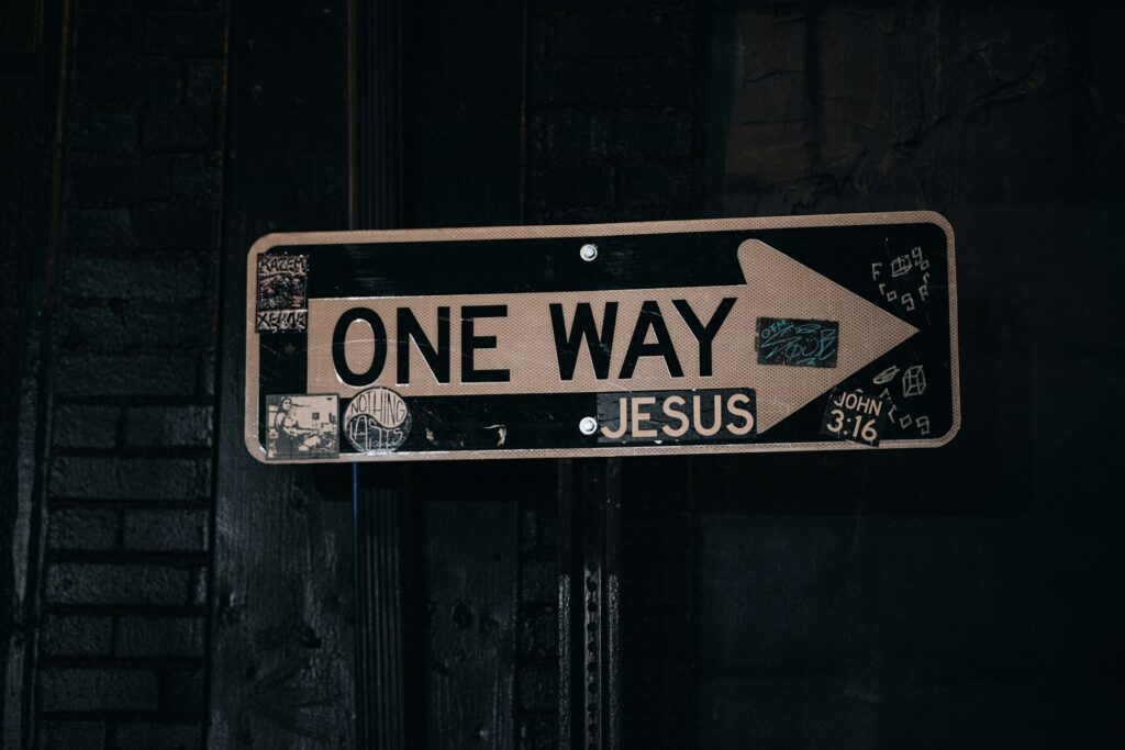 one way sign hanging from the side of a building