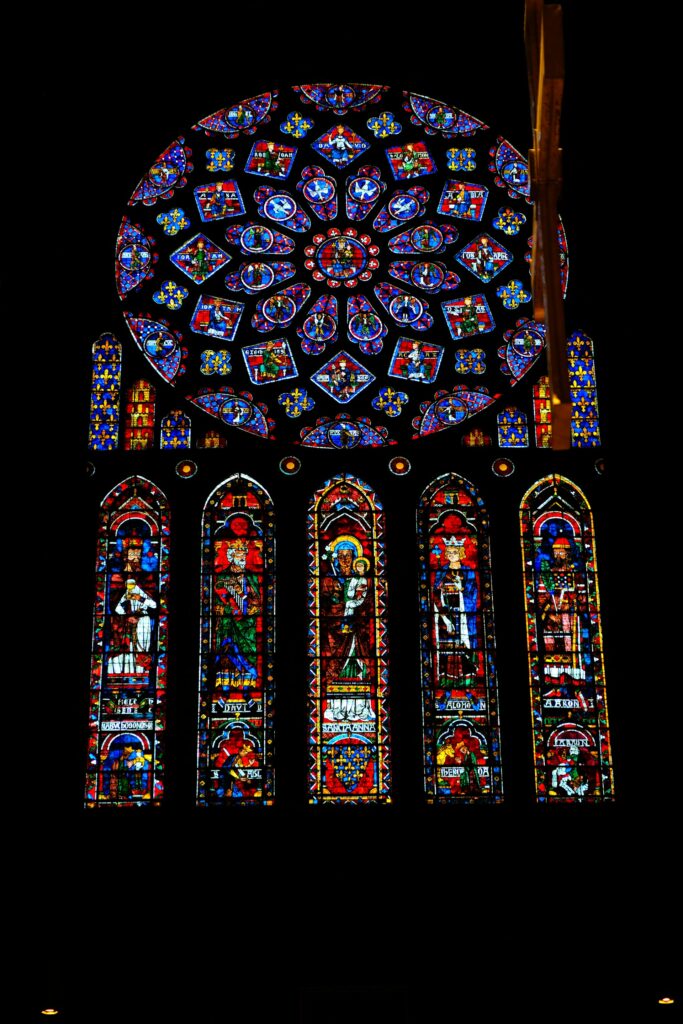 large stained glass window in a building zeroquattro art from unsplash