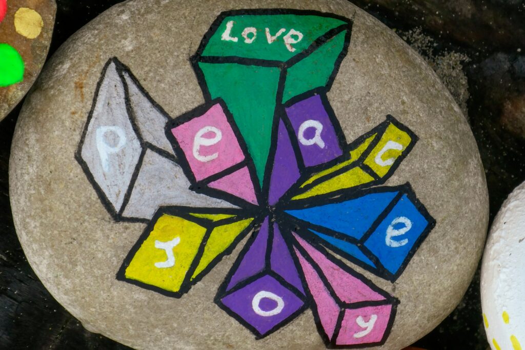 stone written on top peace love joy
