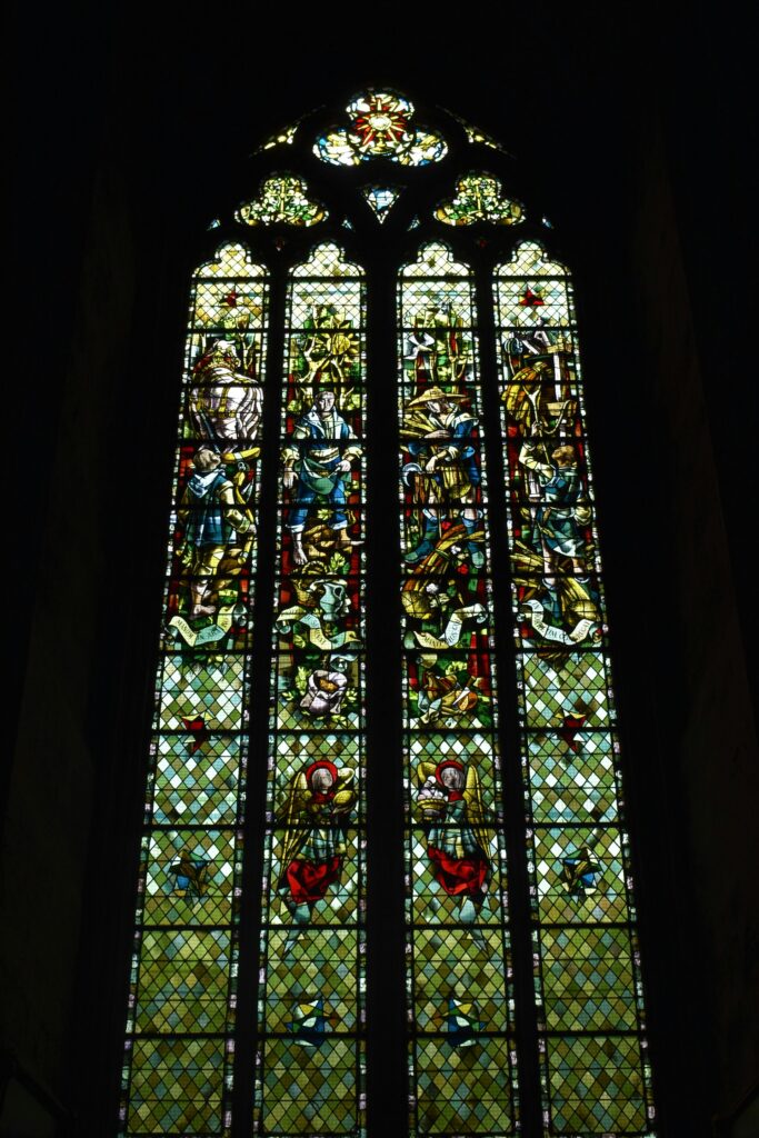 stained glass window with religious figures anna mircea from unsplash